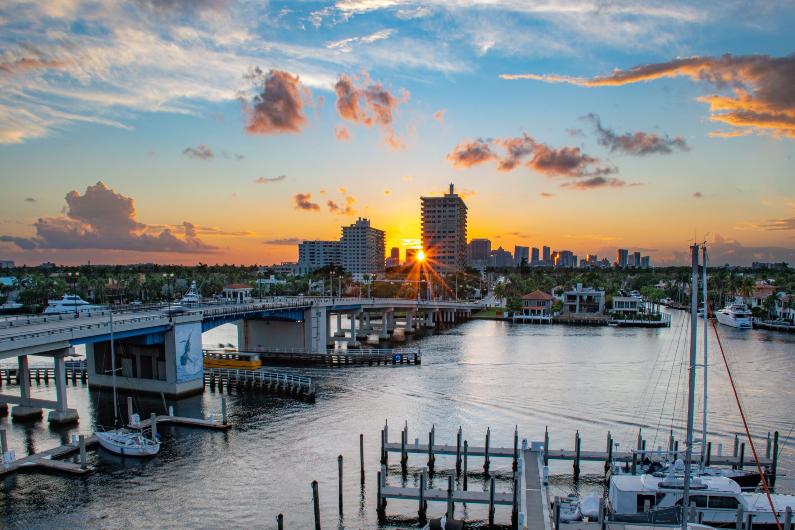 Bridge over canal with boats in Fort Lauderdale city at dusk